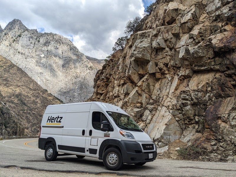 The van parked in front of impressive cliffs