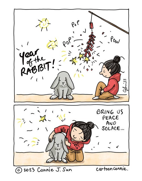 Year of the Rabbit 2023 2-panel illustration of a cartoon girl with bun, kneeling on the ground, looking at a floppy-eared rabbit. In panel 1, a string of fire crackers are going off: "Pop pop pow!" Text reads, "Year of the Rabbit!" in bold script. In panel 2, the girl sidles up next to the rabbit and covers its ears in the ruckus. Text reads, "Bring us peace and solace." Illustration by Connie Sun, cartoonconnie, 2023.