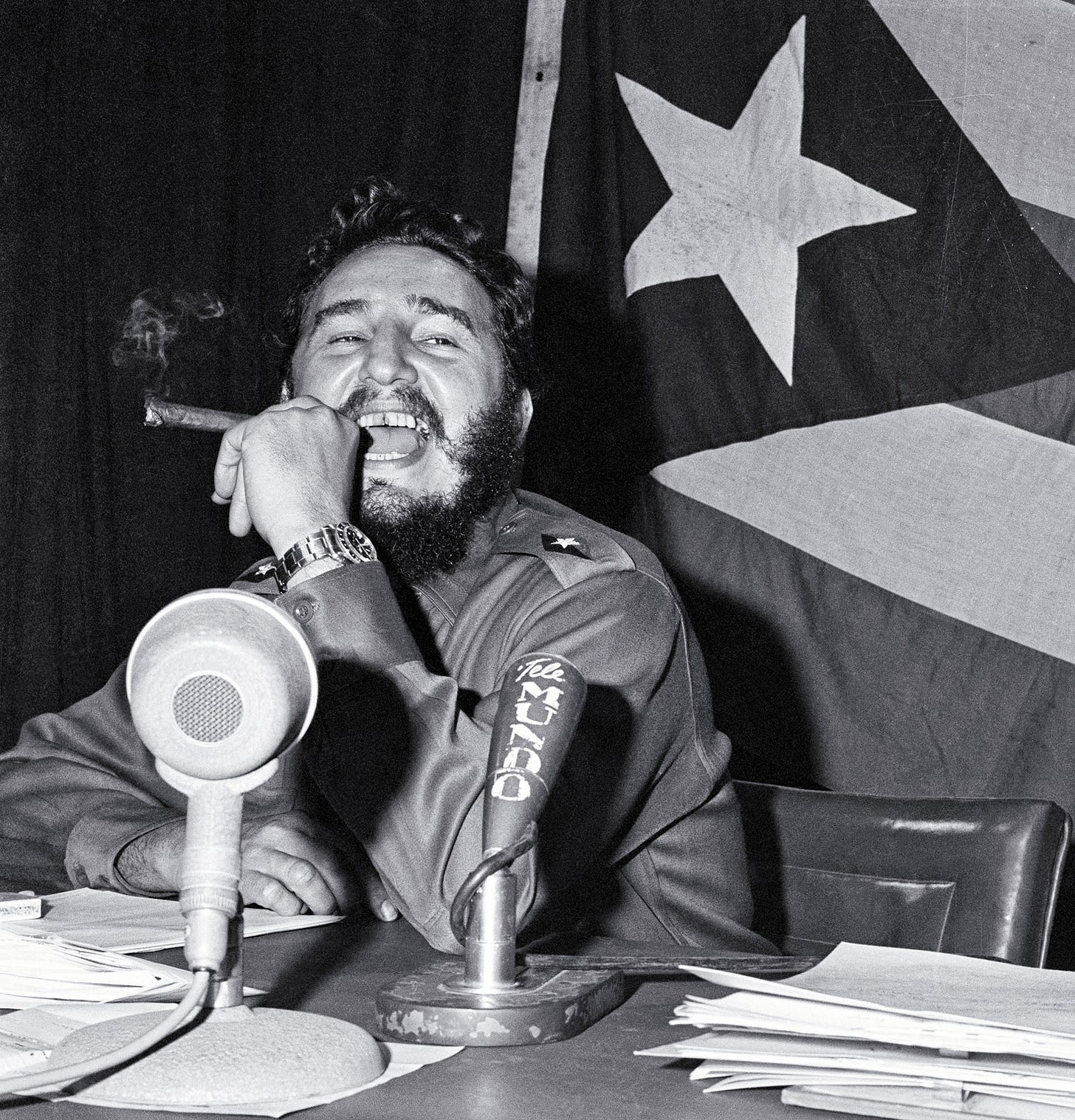 Fidel Castro Laughing with a cigar in front of a microphone : r/colorizebot