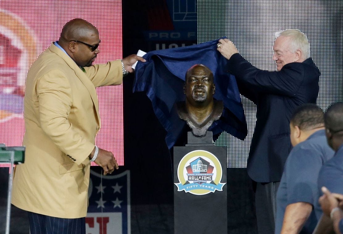 Dallas Cowboys owner Jerry Jones, right, helps Larry Allen unveil his Pro Football Hall of Fame bust  in August  2013, in Canton, Ohio.
