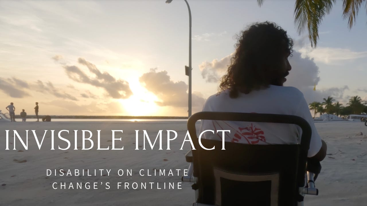 A man with curly hair is sitting on a beach in his wheelchair facing the sea with his back to the camera. The setting sun amid clouds gives a beautiful view. Text on image says “Invisible Impact - Disability on climate change’s frontline.