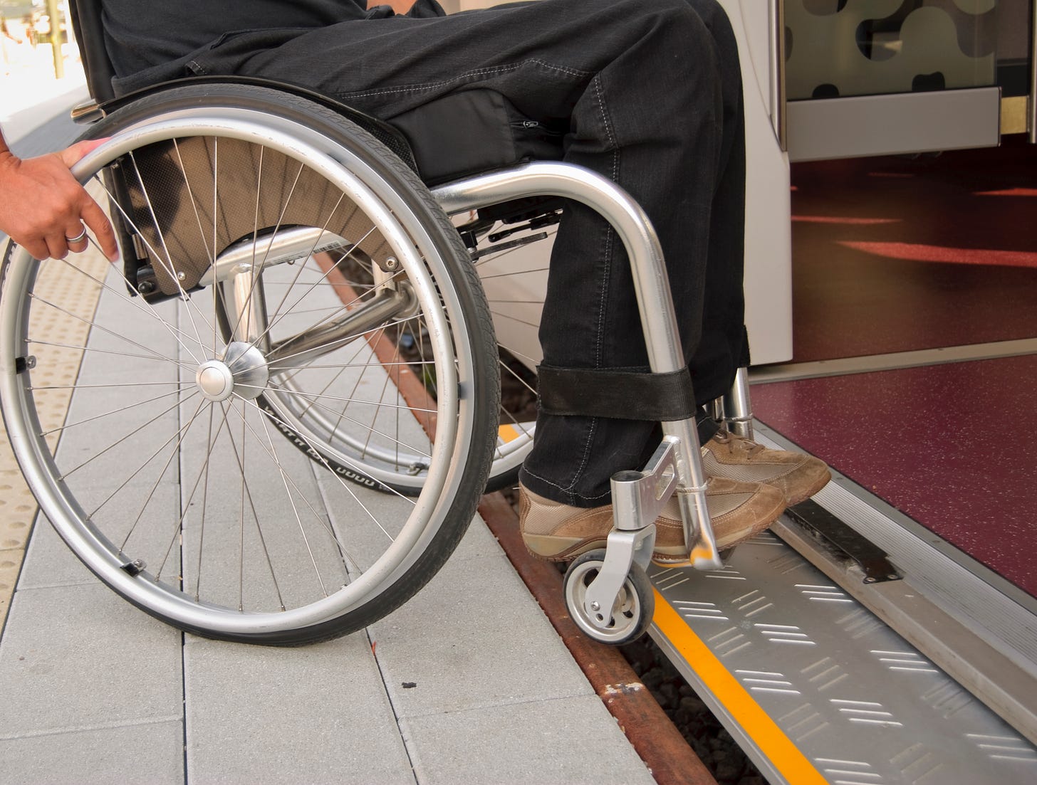 Wheelchair user enters a train with level boarding