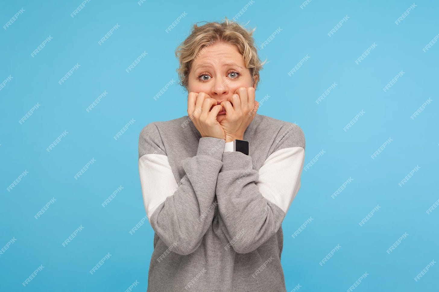 Premium Photo | Neurotic person nervous scared woman with curly hair in  sweatshirt biting nails fingers anxiety disorder feeling stressed worried  about failure indoor studio shot isolated on blue background