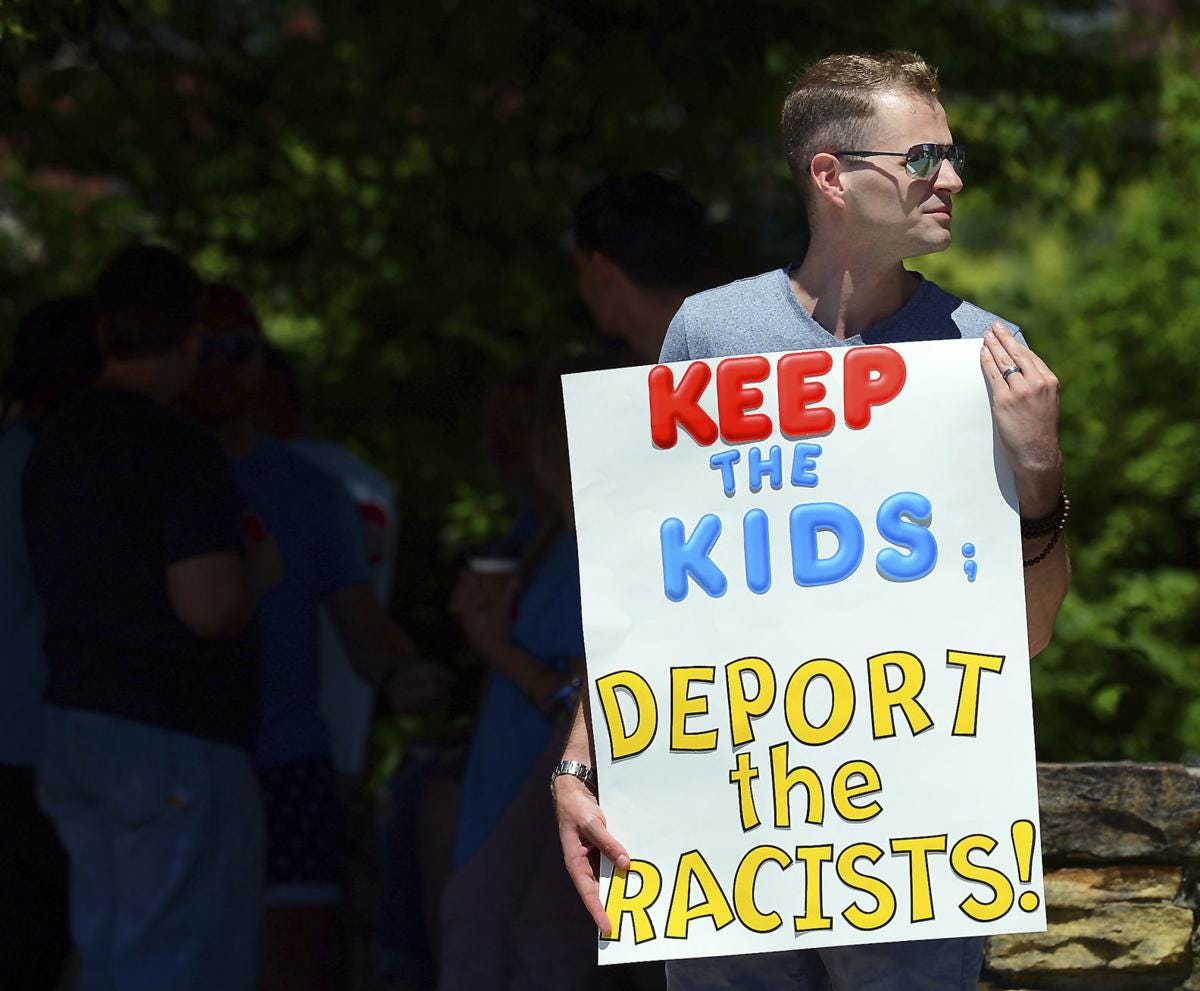 donald trump protestor keep the kids deport the racists banner