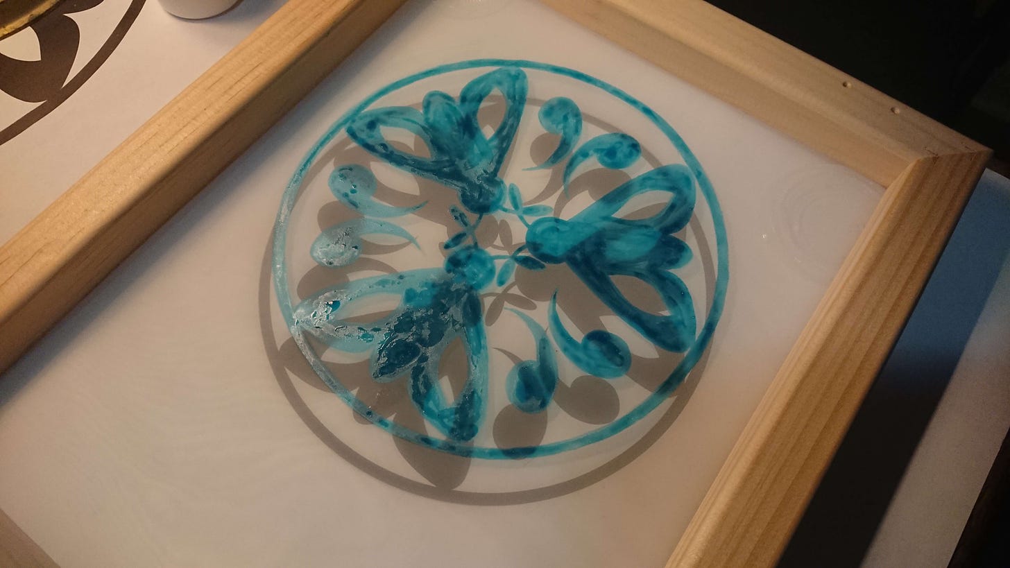 three moths in a circle drawn onto a silk screen with drawing fluid
