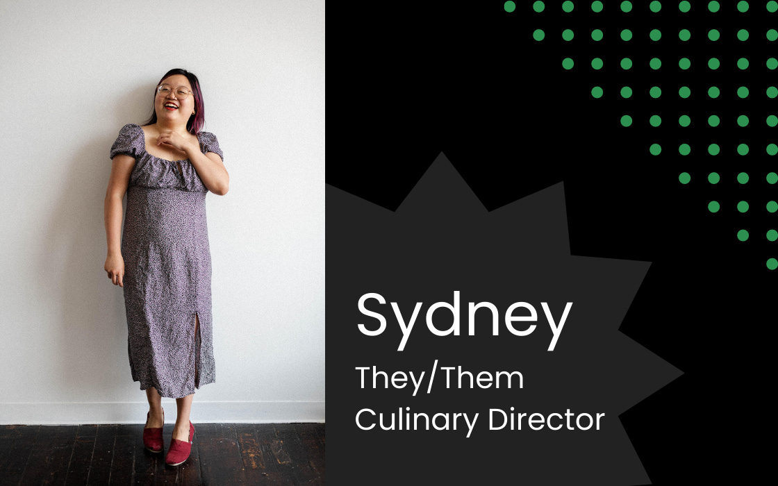 On the left is a portrait of Sydney, a non-binary Asian person. On the right is the text: "Sydney. They/Them. Culinary Director"