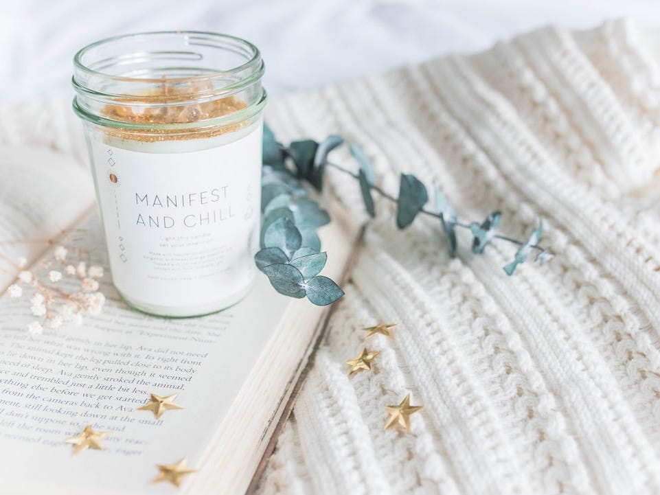 clear glass jar on opened book