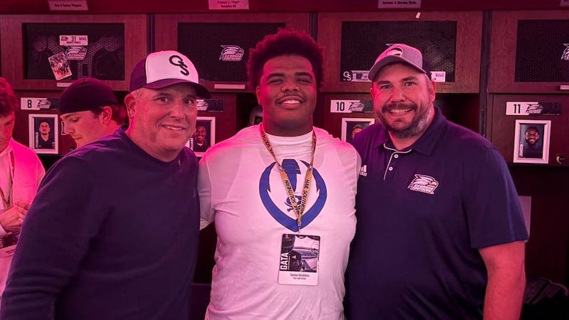 Freshman offensive lineman Tayvian McKibbins poses for a picture with Georgia Southern head...