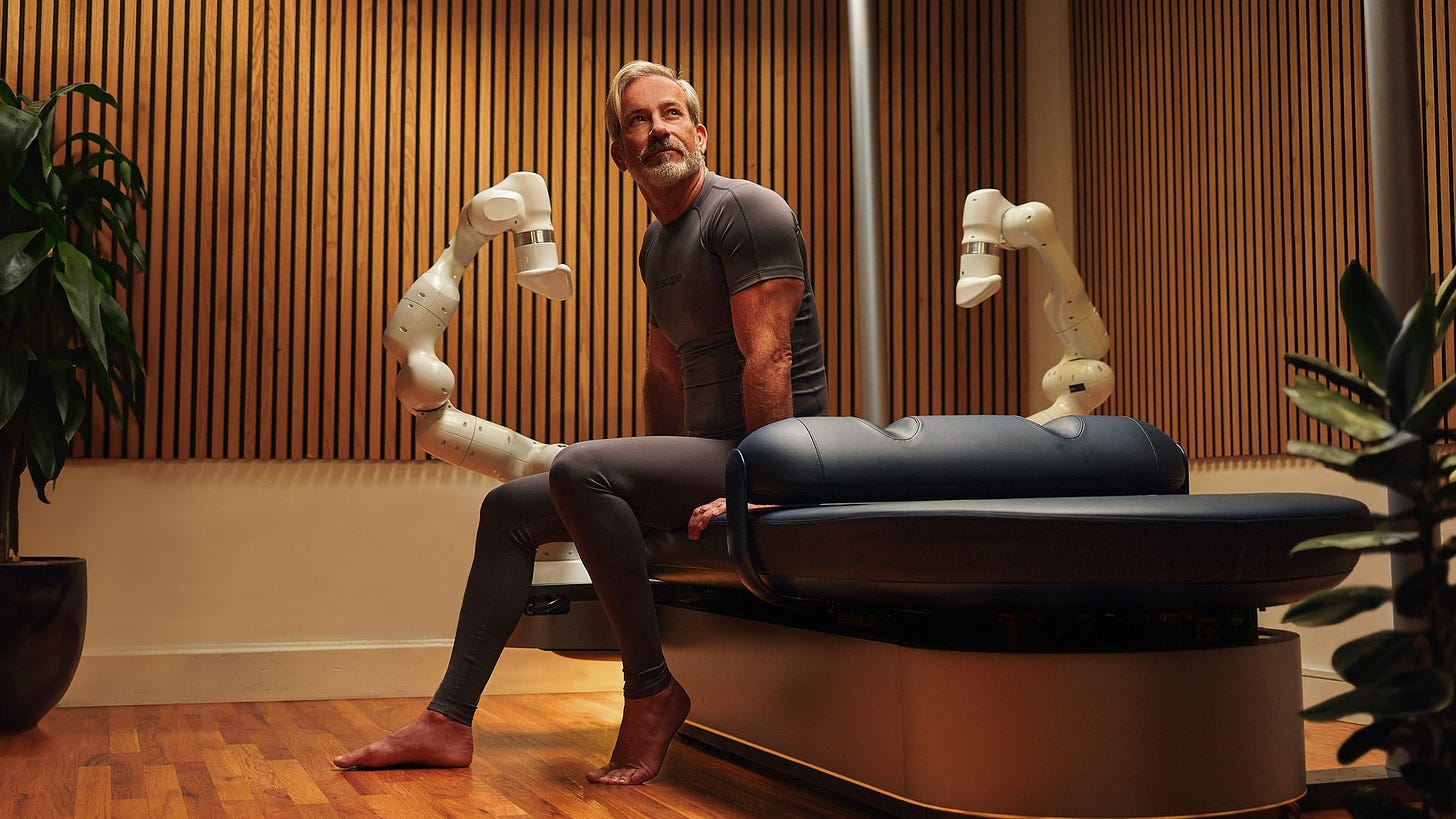 A man poses with an Aescape massage table