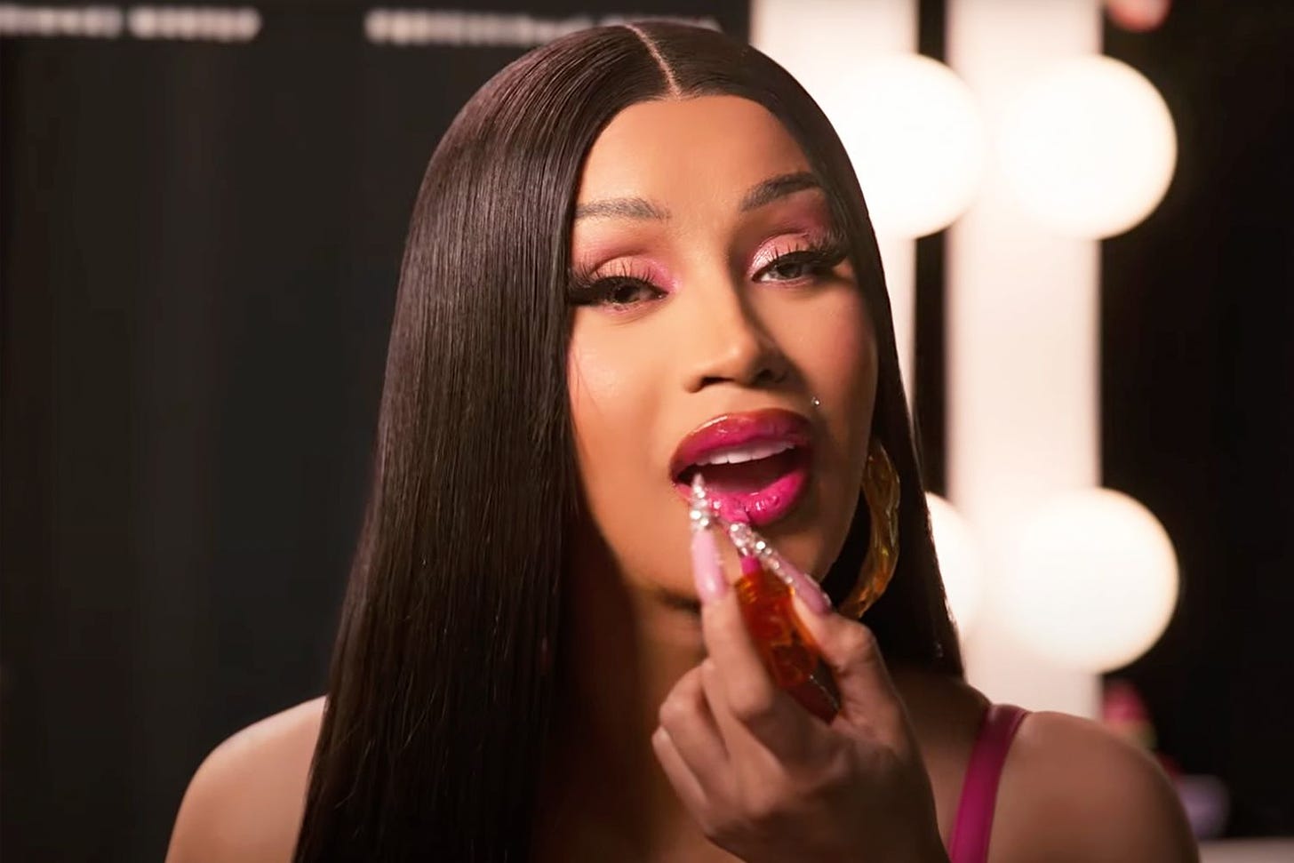 Cardi B applying NYX Lipstick