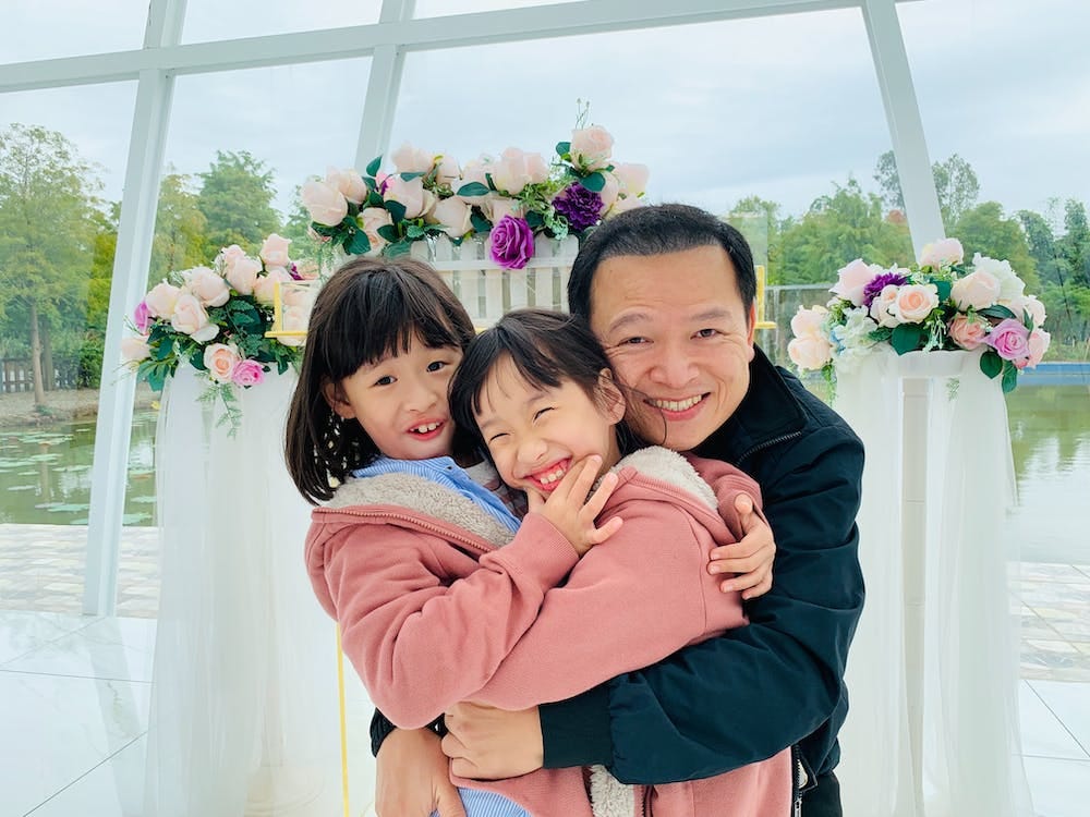 Free Portrait Of Two Girls With Their Father Stock Photo