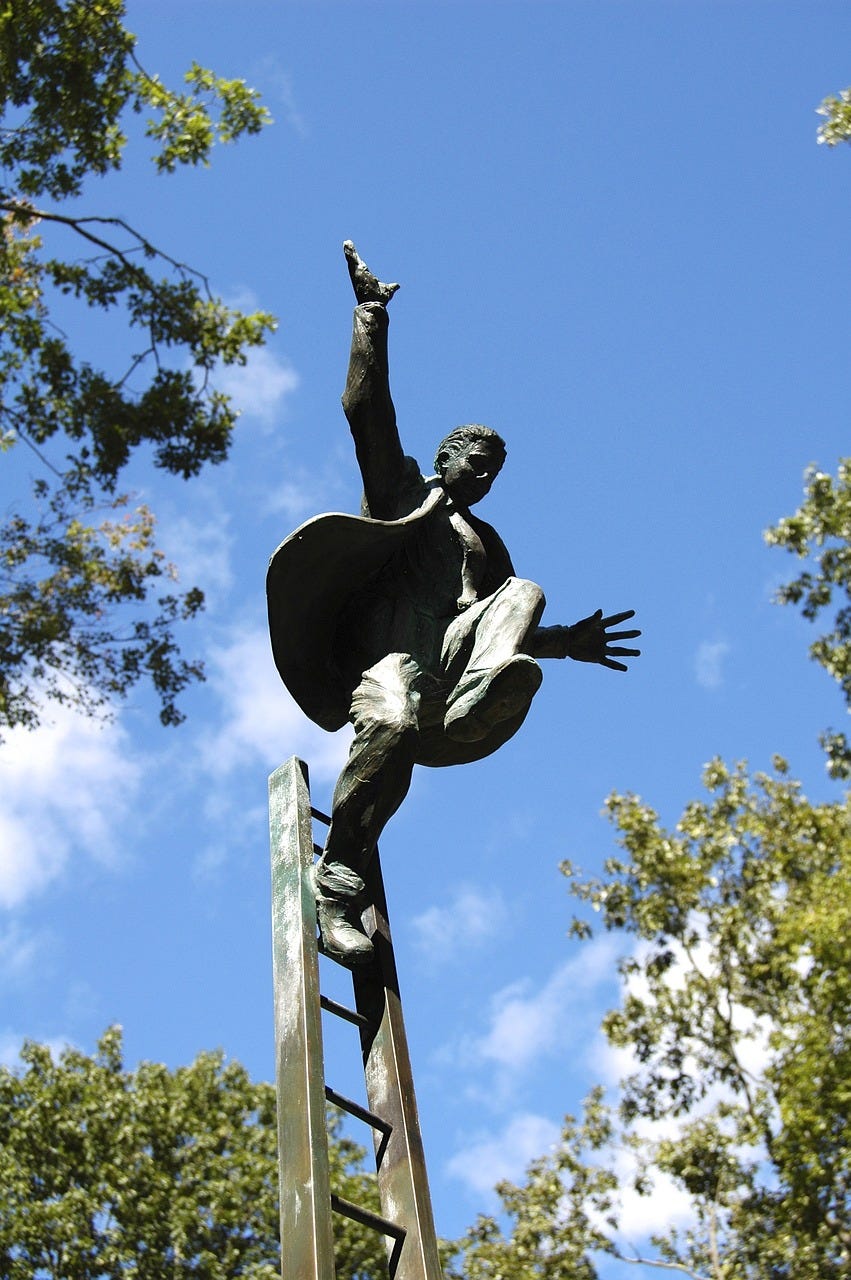 Bronze sculpture of a man balancing precariously at the top of a wobbly ladder