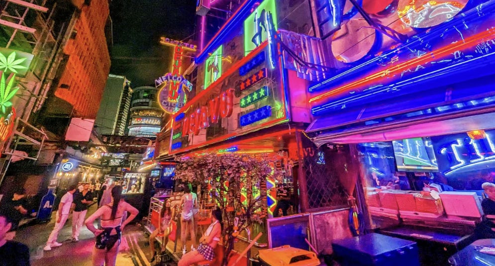 A photo Soi Cowboy filled with tourists and sex workers. 