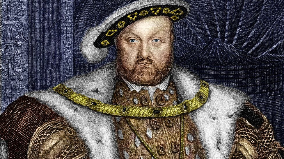 Henry VIII looking very royal in elaborate layers of formal dress.