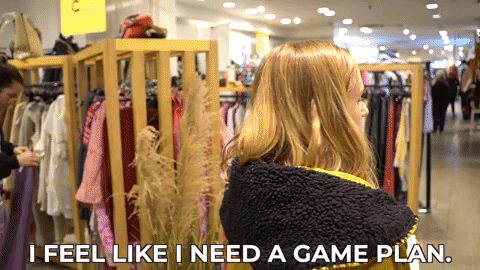 Hannah spinning around in a shop saying, "I feel like I need a game plan."