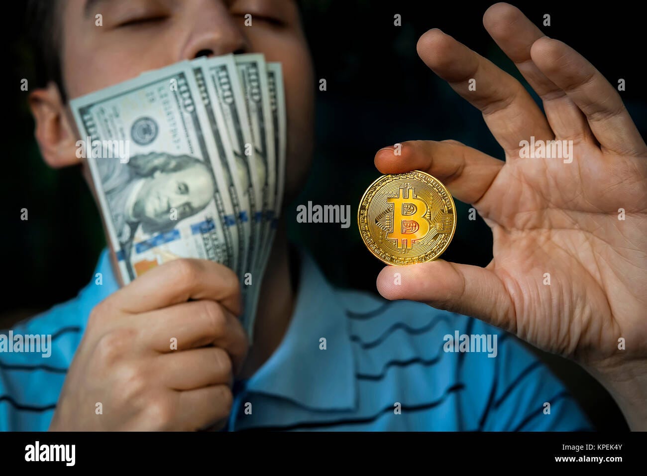 guy holding the coin bitcoin and money in hand. margin, profitable, spoil,  lucre, increment. Earnings on the mining of cryptocurrencies. Profit from m  Stock Photo - Alamy