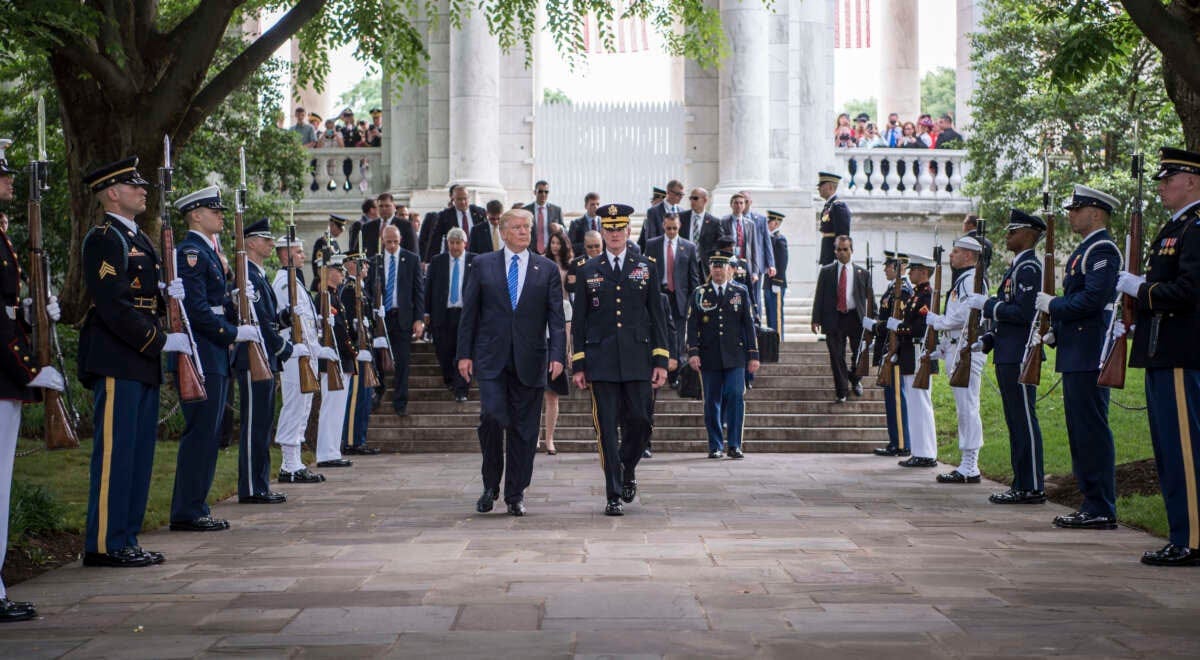 President Donald Trump leaves after attending a Memorial Day ceremony at Arlington National Cemetery in Arlington, Virginia, May 28, 2017. Two military aides carrying two “nuclear footballs” can be seen walking behind and to the right of Trump.