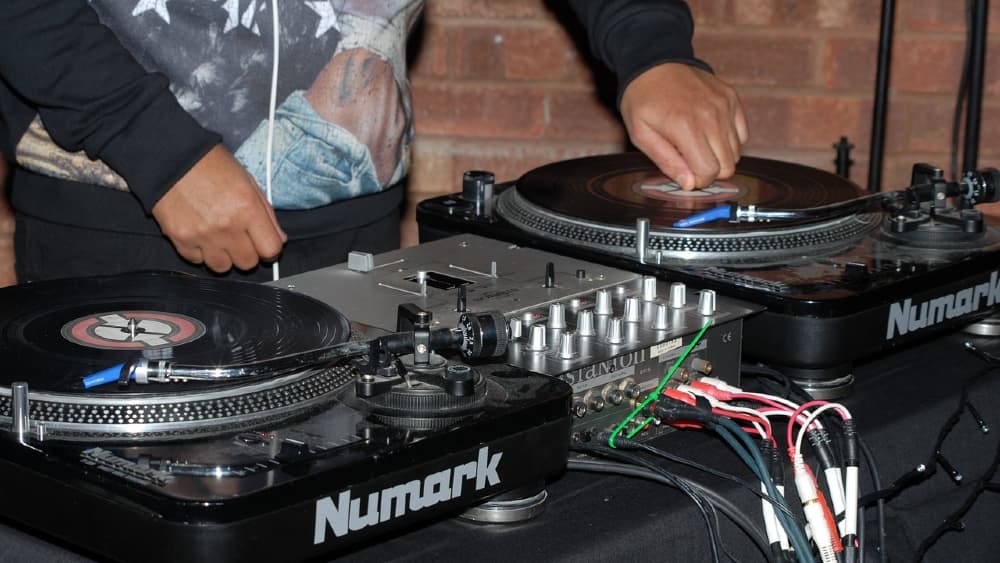 A DJ spinning music on two turntables