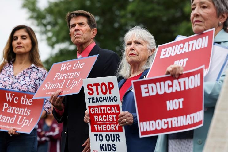 Protesters outside Loudoun County School Board headquarters holding signs pertaining to Critical Race Theory in Ashburn, Virginia.