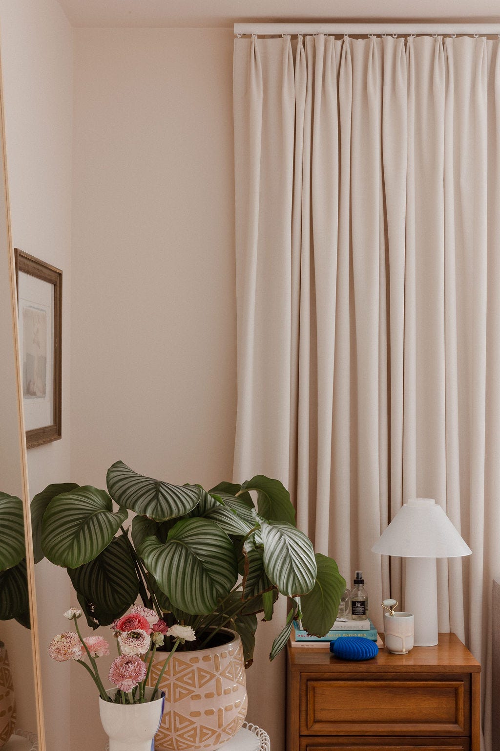 beige draperies in a bedroom designed by ashley izsak