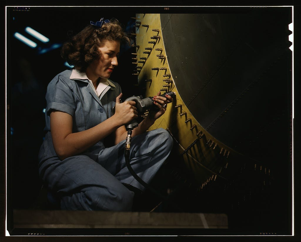 Riveter at work on Consolidated bomber, Consolidated Aircraft Corp., Fort Worth, Texas