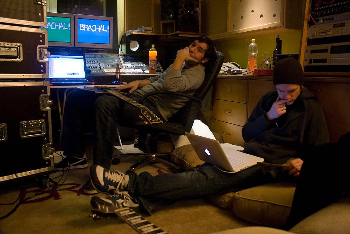 the author in a recording studio with a guitar on his lap