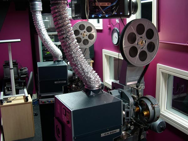 Side-by-side 35mm projectors with changeover mechanism