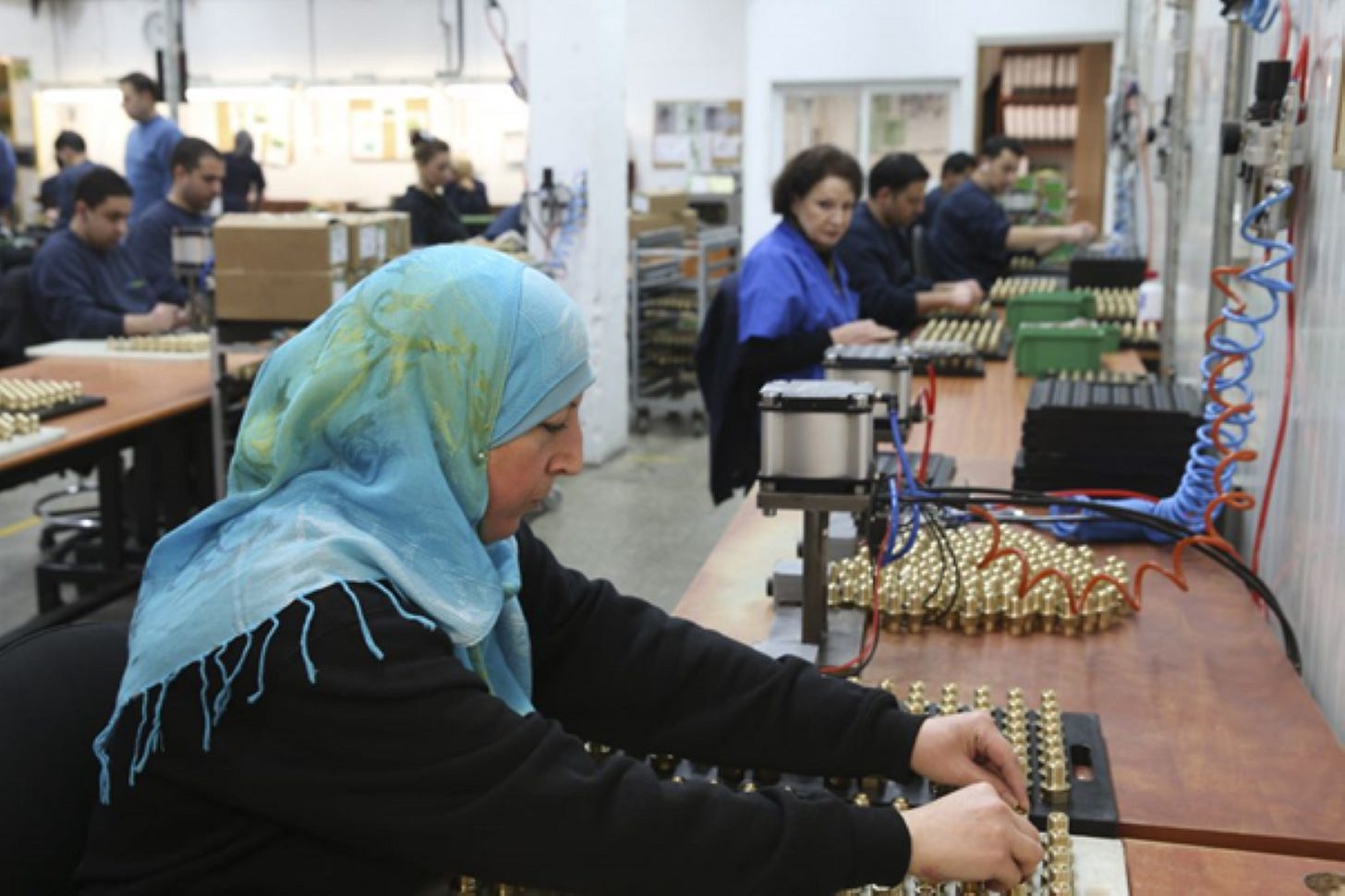 Arab men and women working in SodaStream factory that was later closed due to BDS pressure.