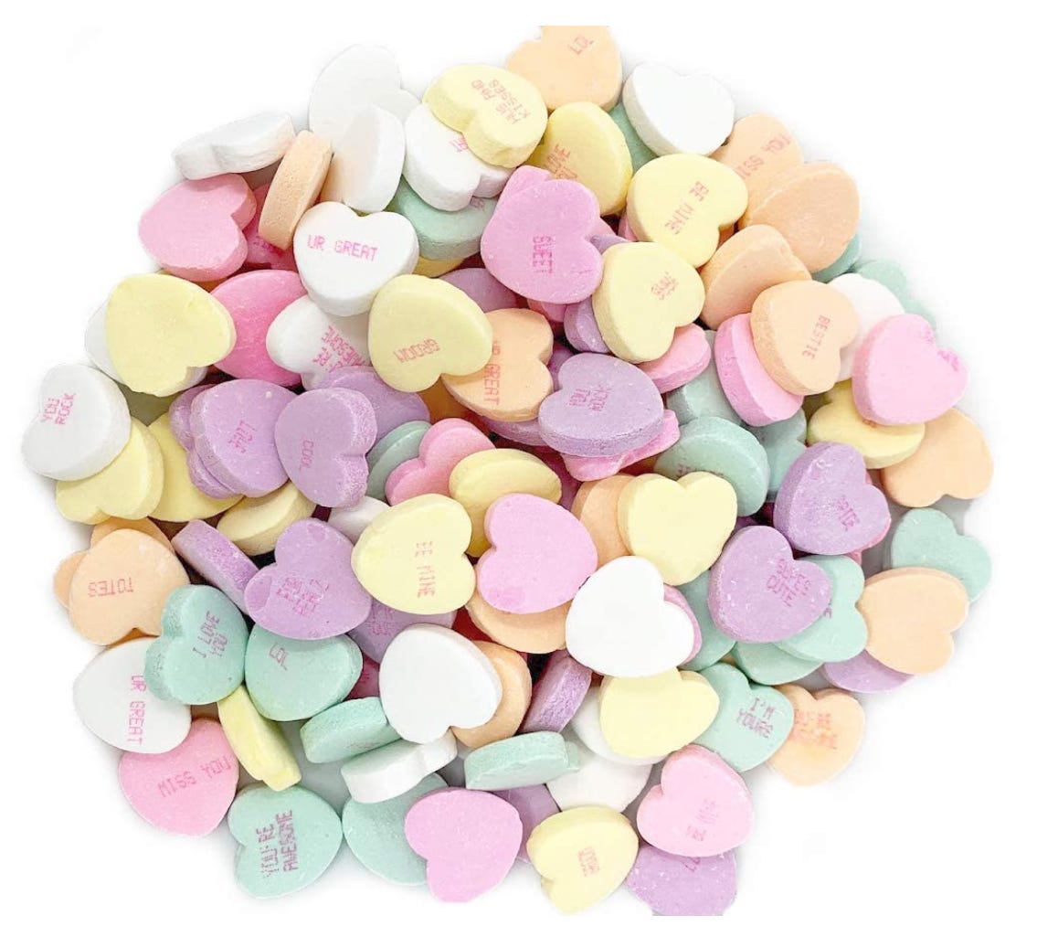 An assortment of conversation hearts, looking not especially appetizing.