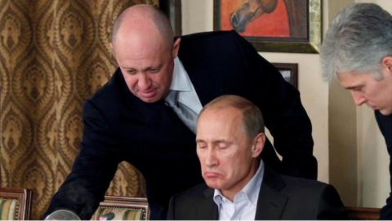 Yevgeny Prigozhin serves food to Vladimir Putin