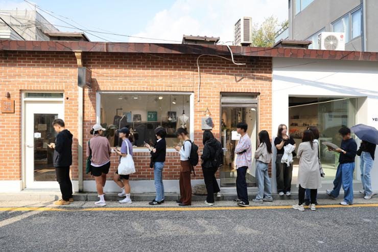 People line up in front of  an independent bookstore in Jongno District, Seoul, run by novelist Han Kang, waiting for it to open, Friday.