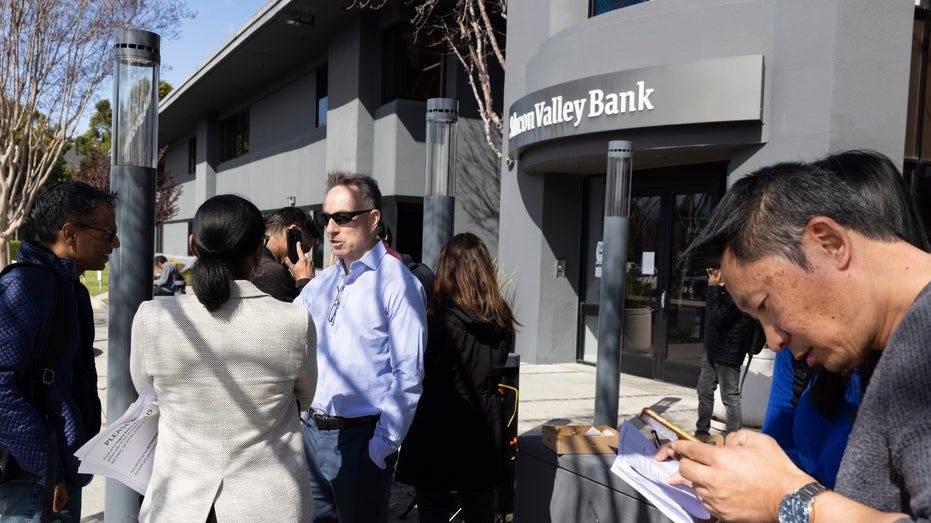 Silicon Valley Bank customers wait outside branch