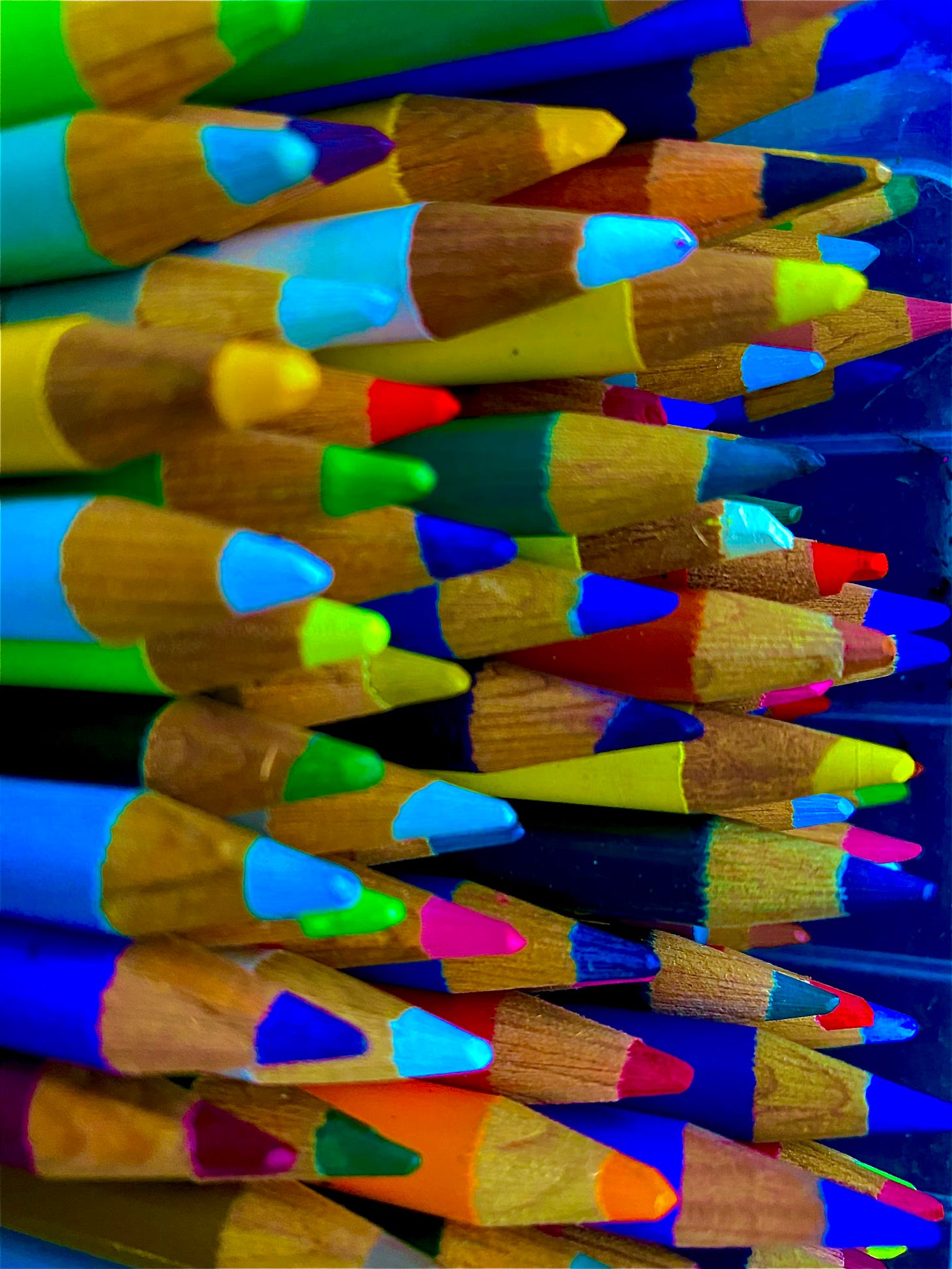 A closeup view of brightly coloured pencil crayons edited to appear unusual in vibrant colours