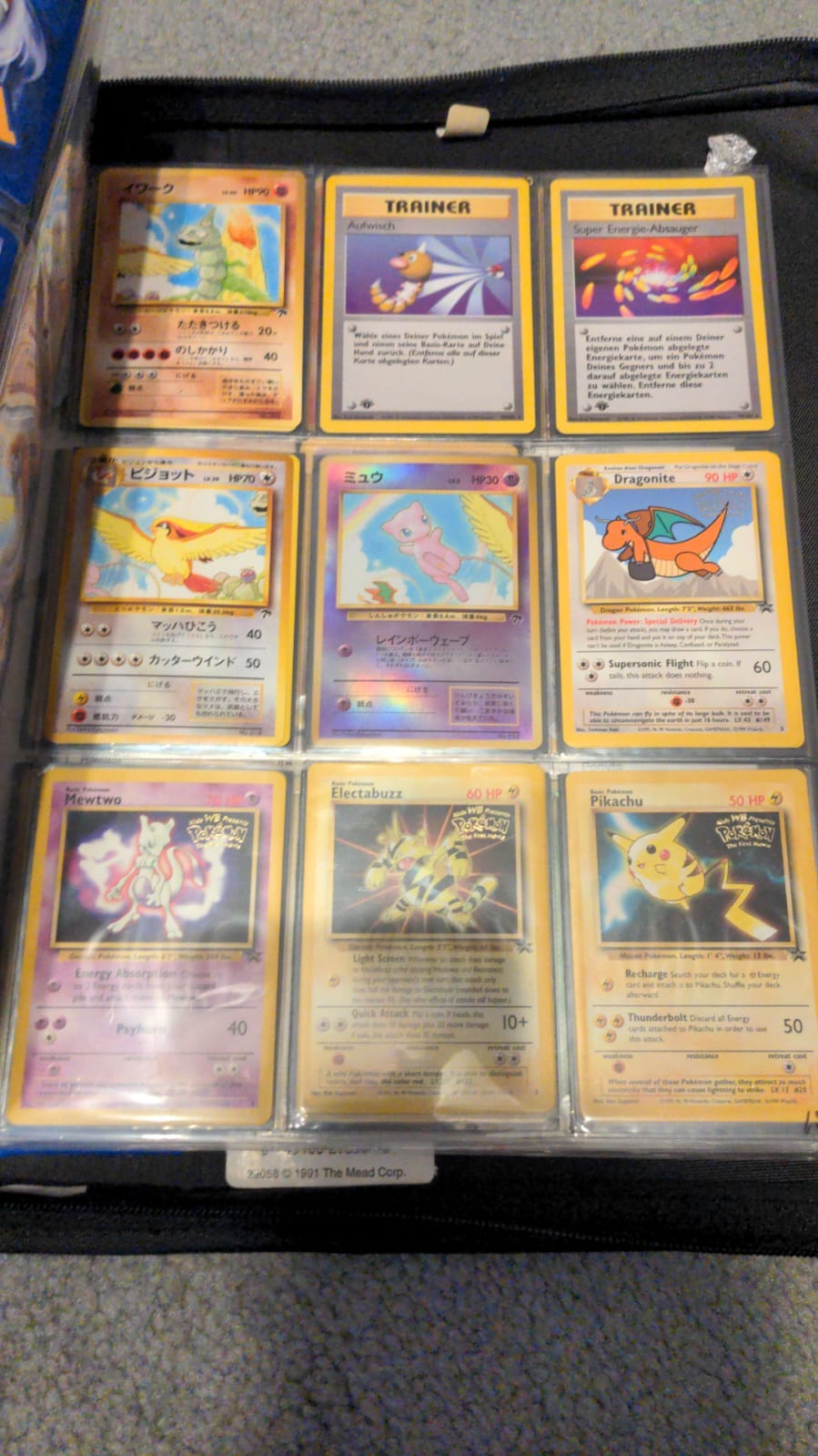 This photograph shows a few of Ryan’s Pokémon trading cards, including a Japanese promo card of Pikachu