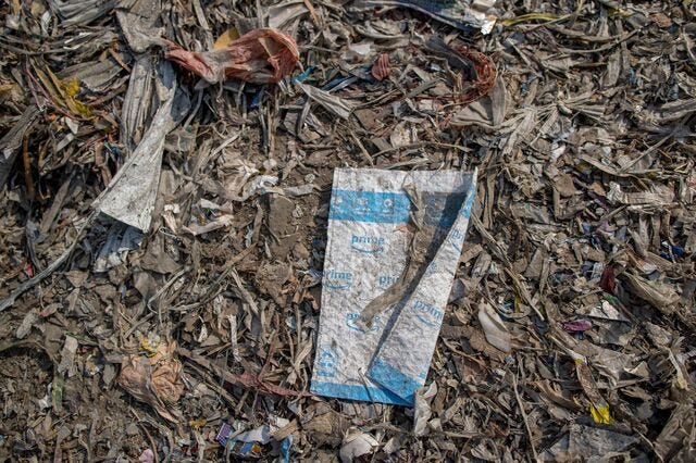 Waste discarded from paper mills as plastic and other items belonging to foreign brands are strewn around at a plastic scrap contractors yard, in Muzaffarnagar District, Uttar Pradesh, India, on Saturday, Nov. 19, 2022.