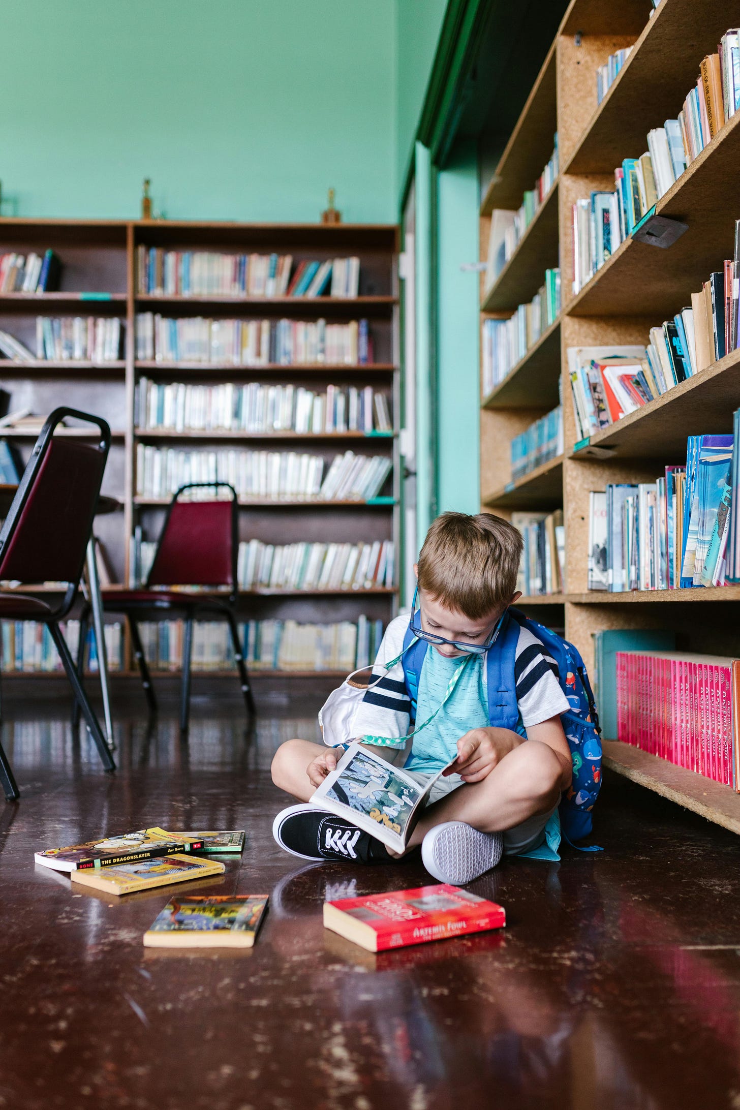 Photo of a Boy Reading a Book on the Floor · Free Stock Photo