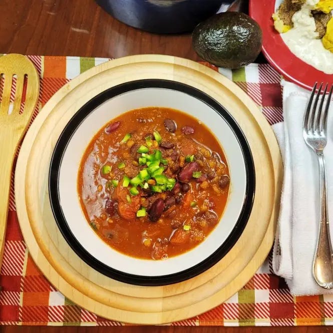 Featured image: WFPB Lentil Chili in a bowl ready to eat warm in a bowl