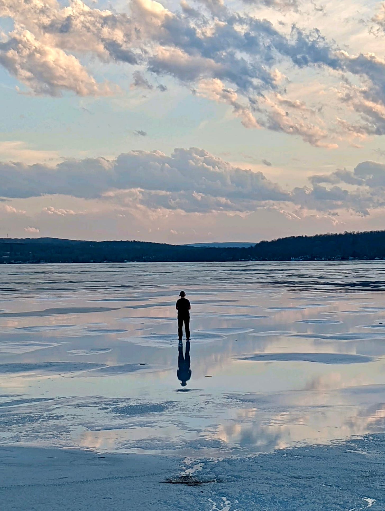 May be an image of 1 person, lake and twilight