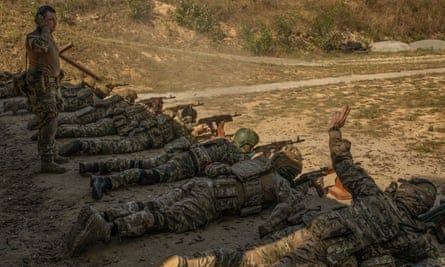 New RDK recruits at a firing range near Kyiv firing rounds from automatic weapons at targets