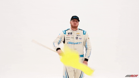 Racing official waving a yellow caution flag — used in Beating the Tide’s TCBX stock analysis to signal slowing growth and caution in short-term bank stock investing.