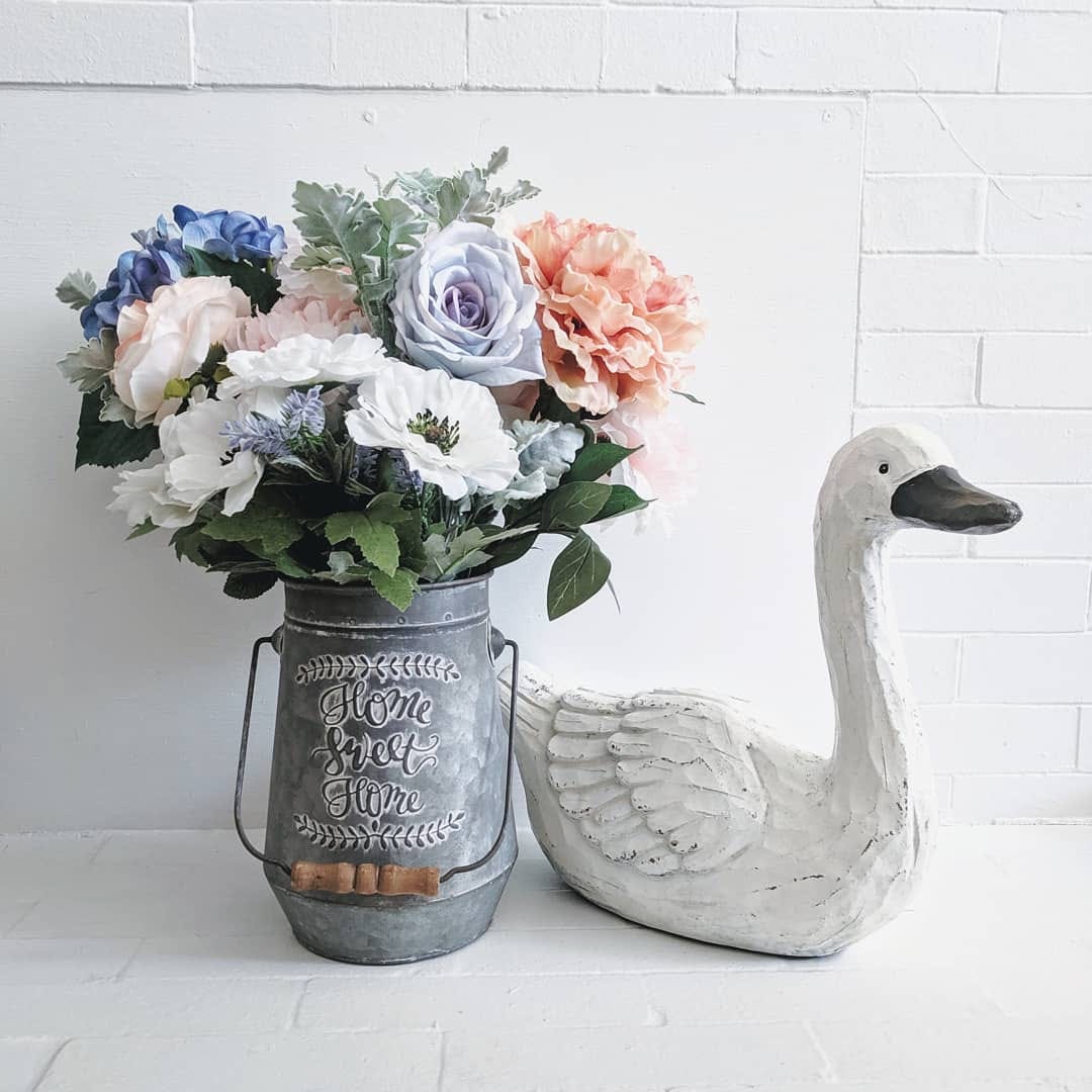 arrangement of fake florals in a bucket