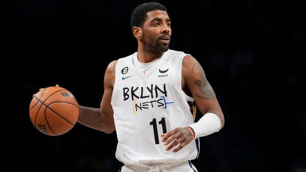 Kyrie Irving wearing a white No. 11 Nets jersey while dribbling a basketball in his right hand.