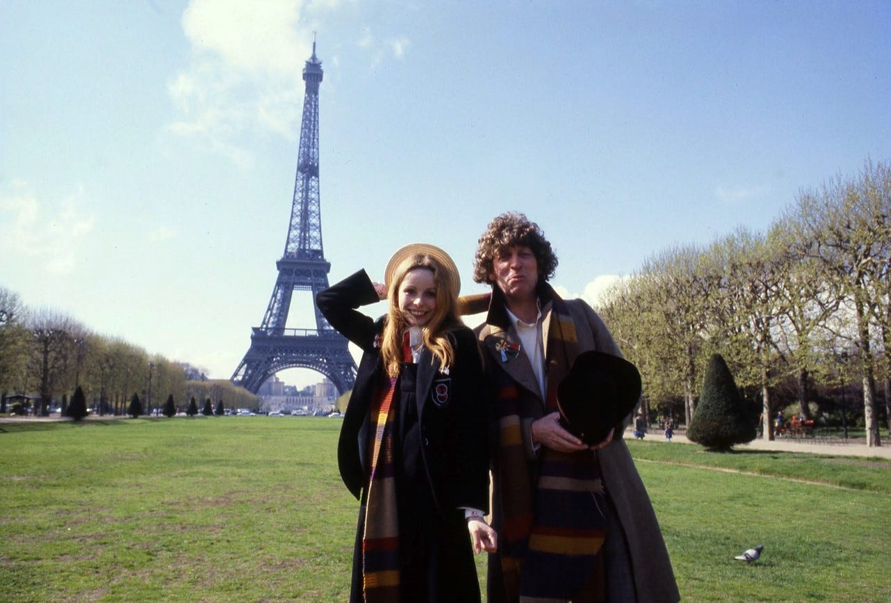 Tom Baker as Dr Who and Lalla Ward as Romana in front of the Eiffel Tower in a publicity photo for City of Death (1979)