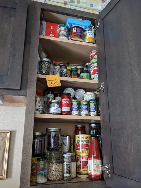 a stocked cabinet of canned goods