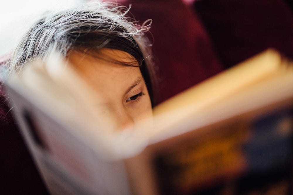 Close up view of a reader with eyes focused on opened book.