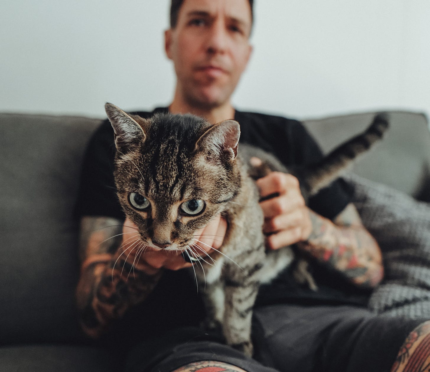 Chris and his cat Harry on a couch