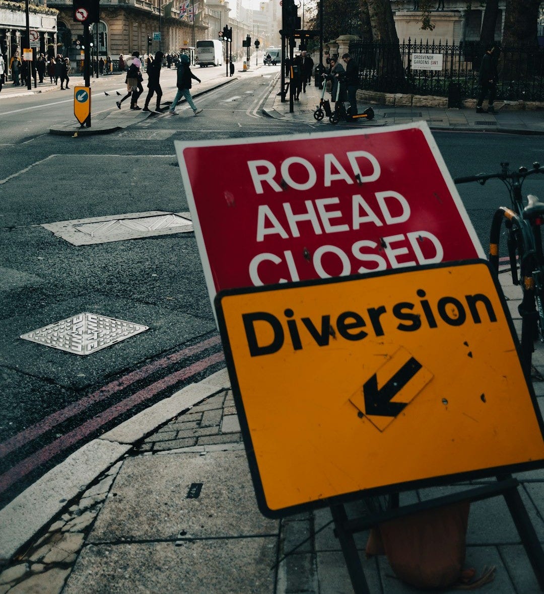 a road ahead closed sign on the side of the road