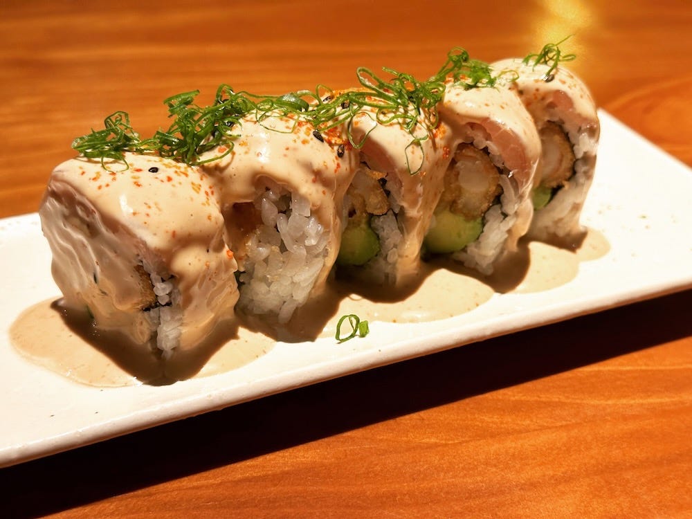 Acevichado rolls at Fan in Miraflores, Lima. The roll is smothered with creamy ceviche sauce.