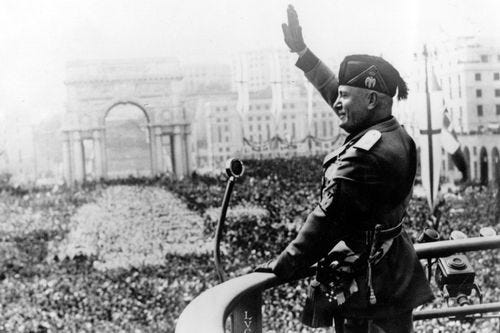 Italy's Benito Mussolini salutes during a public address circa 1938.