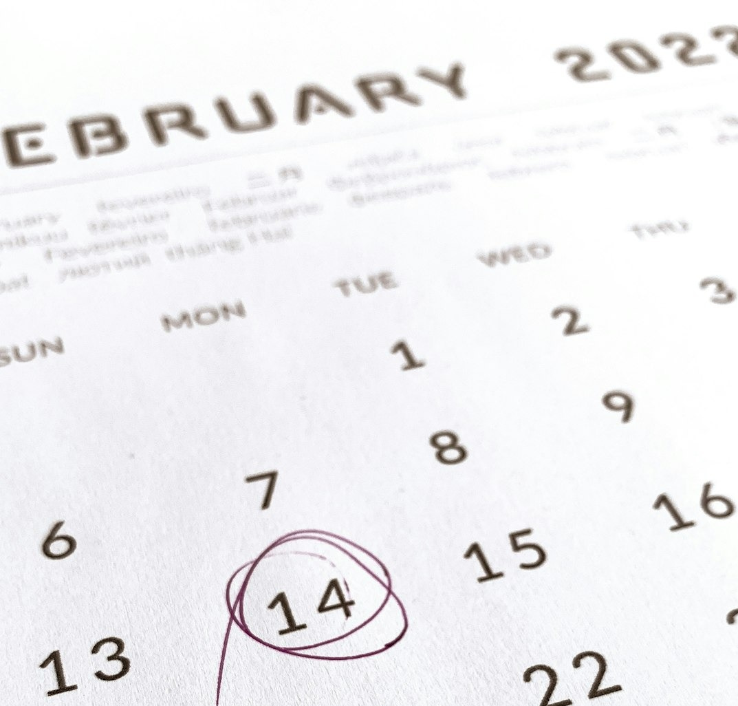a close up of a calendar with a red marker a close up of a calendar with a red marker
